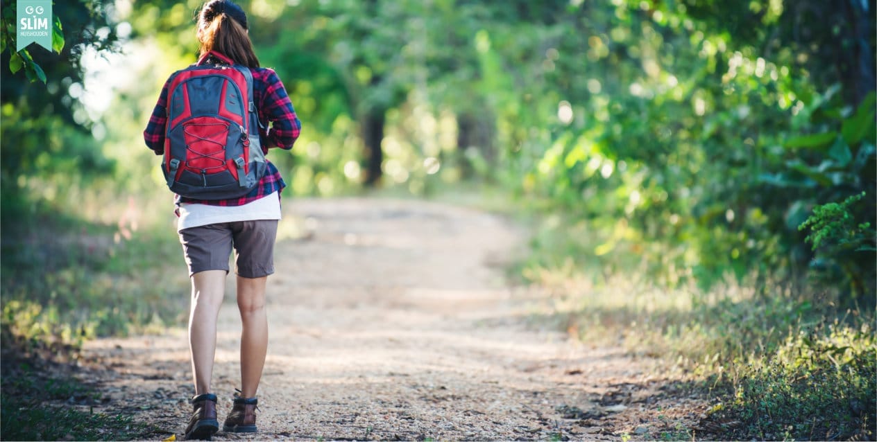 Blog Comfortabele wandelsokken Dec 2025 123RF 77298207_l vrouw wandelt over een natuurpad met rugzak en comfortabele wandelsokken